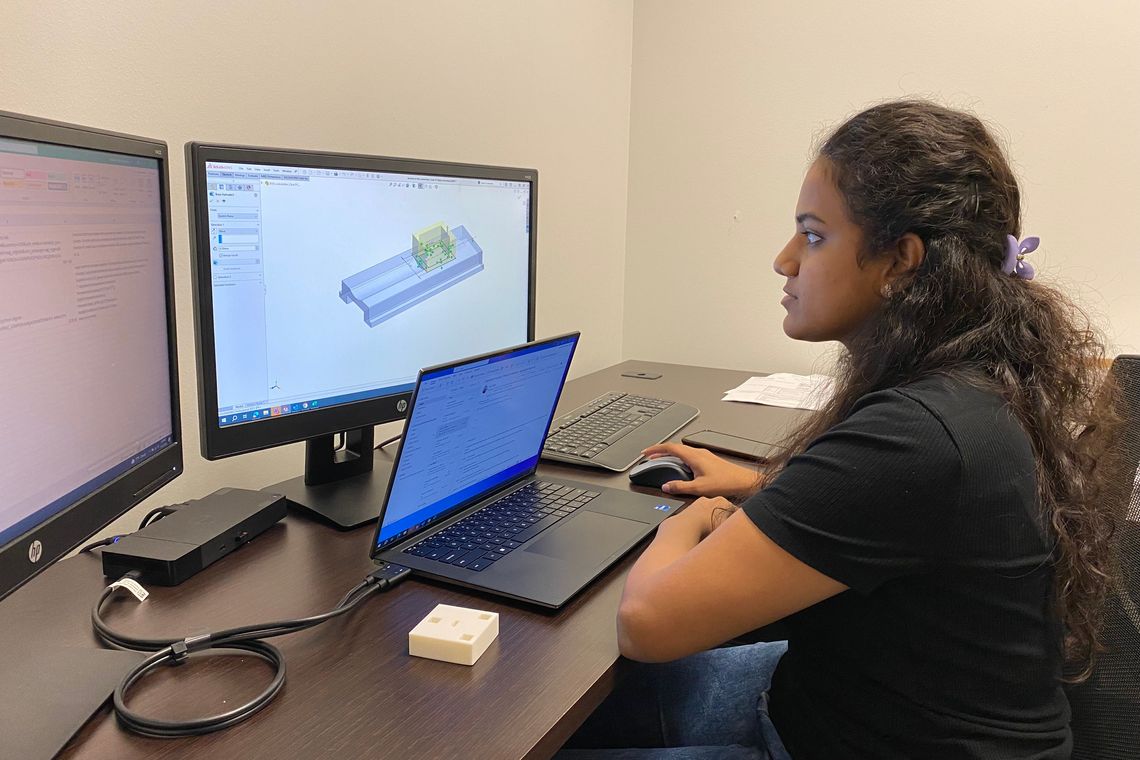intern working on a dual monitor computer